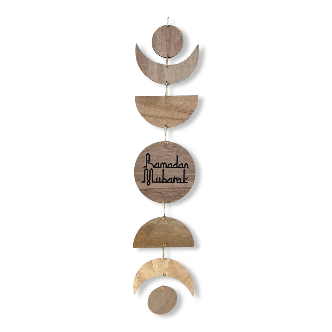 A wooden moon phase wall hanging for Ramadan